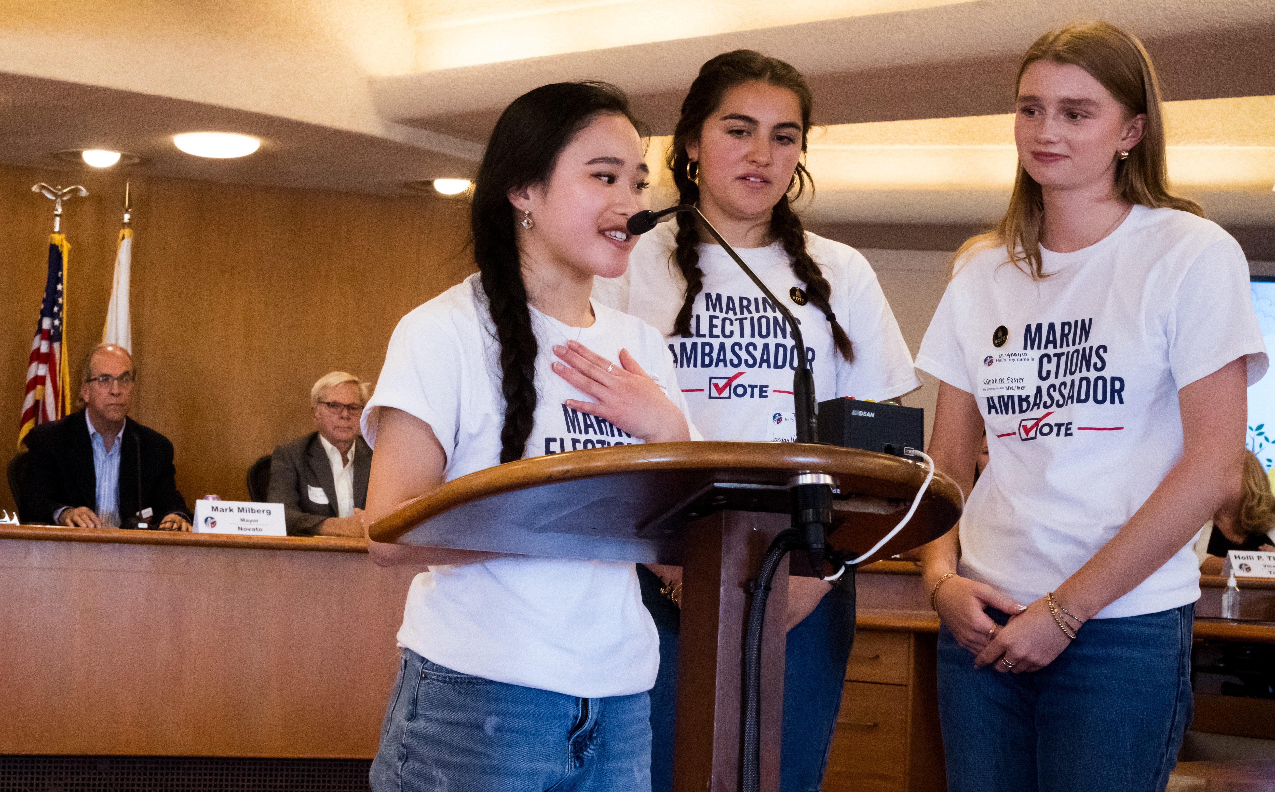Three young girls speak at the microphone during the Board hearing.